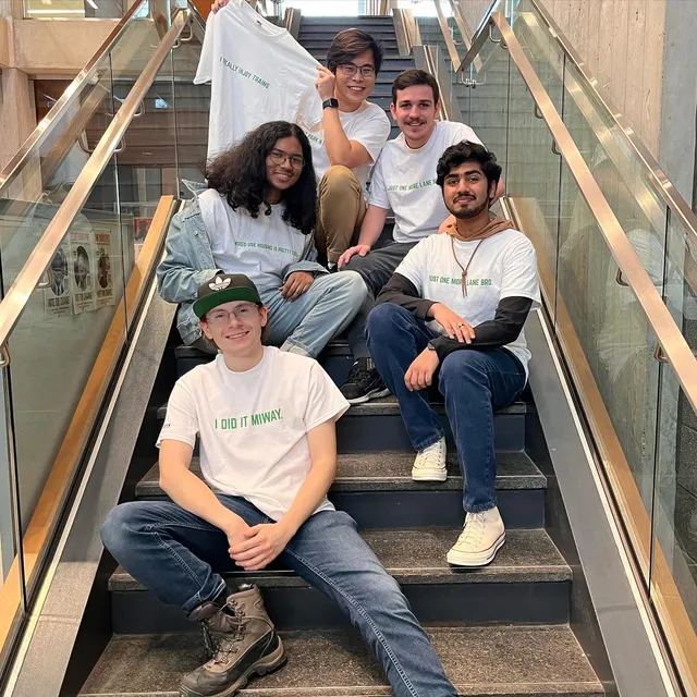 UTM Urbanism Club members on the CCT staircase, wearing club t-shirts with transit and urbanism jokes